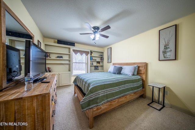 bedroom with ceiling fan, baseboards, and carpet floors