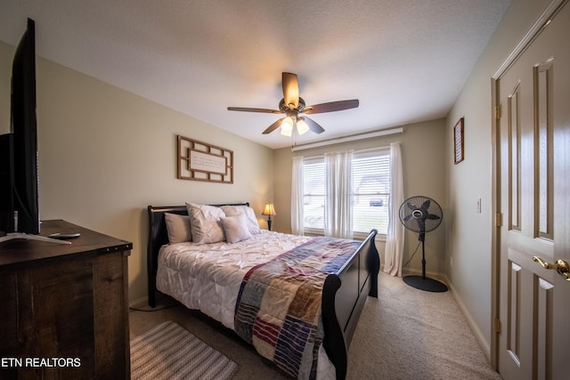 carpeted bedroom featuring a ceiling fan and baseboards