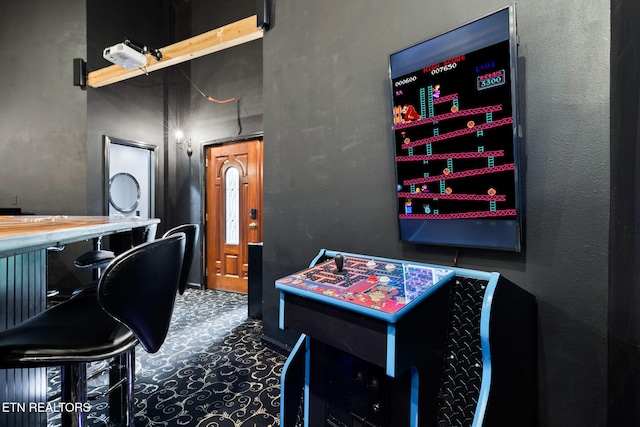 game room featuring a textured wall