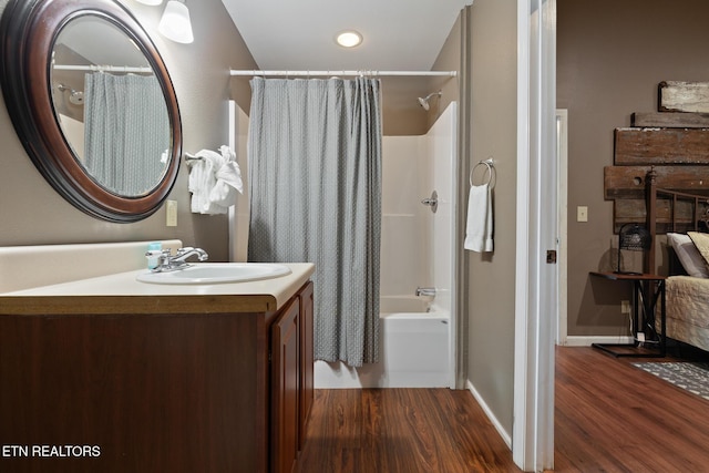 full bathroom featuring shower / bath combination with curtain, vanity, baseboards, and wood finished floors