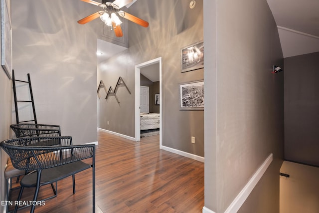 hallway featuring wood finished floors and baseboards