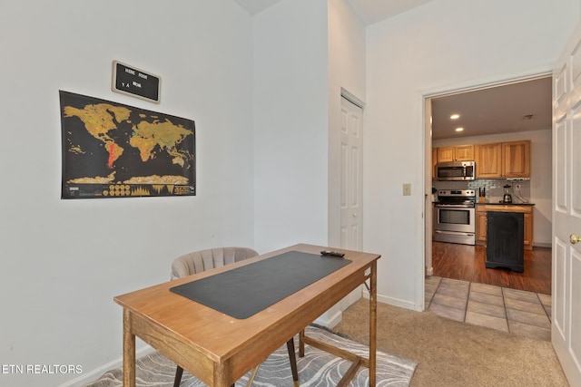 office space featuring recessed lighting, baseboards, and light colored carpet