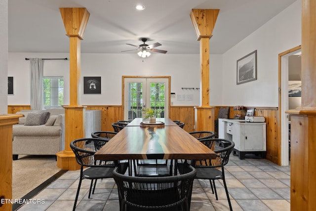 dining area with a wainscoted wall and wood walls