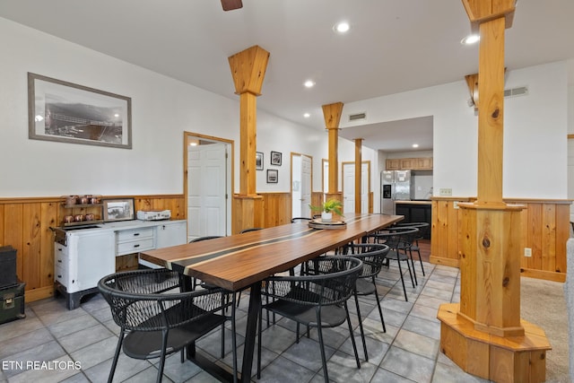 dining room with visible vents, a wainscoted wall, recessed lighting, wooden walls, and decorative columns