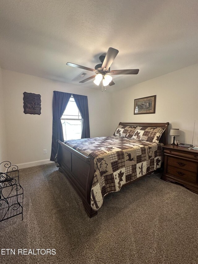 carpeted bedroom featuring baseboards, a textured ceiling, and a ceiling fan