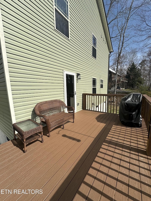 wooden deck featuring a grill