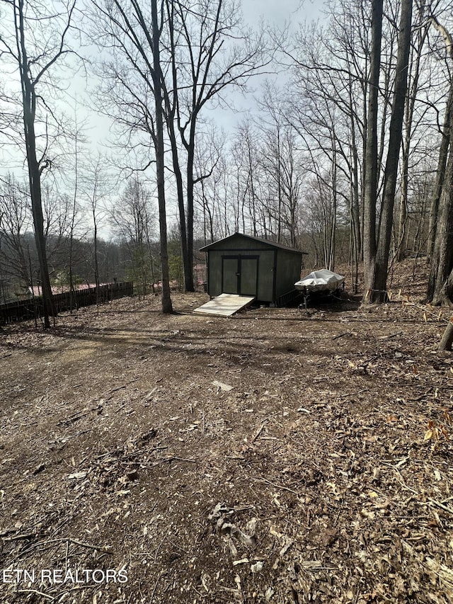 view of yard with an outbuilding, a shed, and a detached garage