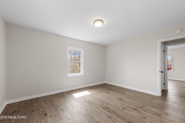 unfurnished room featuring wood finished floors and baseboards