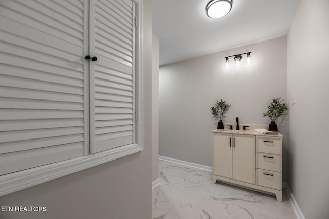 hallway with baseboards and marble finish floor