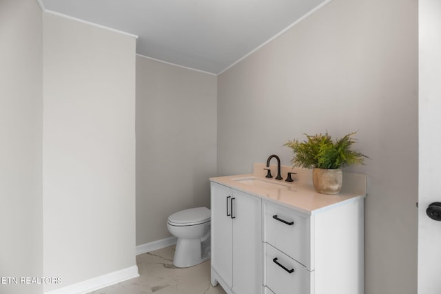 half bathroom featuring marble finish floor, toilet, vanity, and baseboards