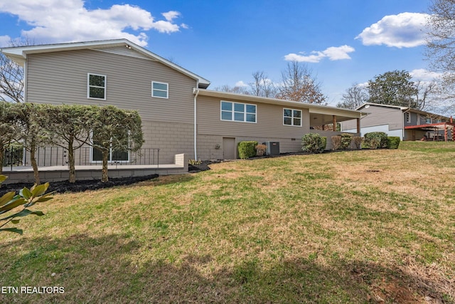 rear view of house with a yard and central AC unit