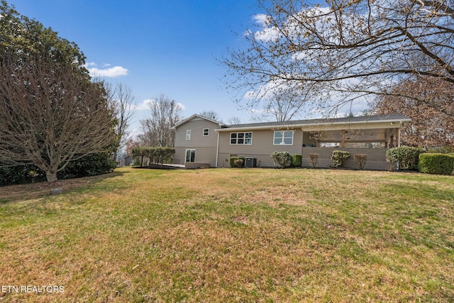 rear view of house featuring a lawn