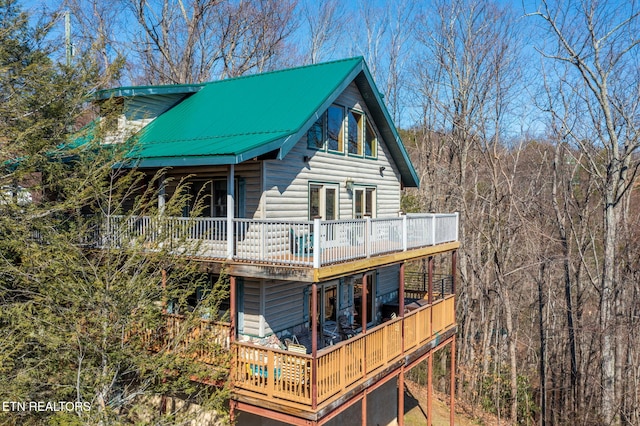 940 Stans Rd, Gatlinburg, TN 37738 - view of side of home with faux log siding, a wooden deck, and metal roof