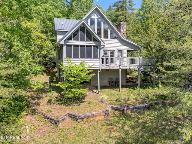 413 Settlers Rise Rd, Townsend, TN 37882 - rear view of house featuring a chimney, a wooden deck, a sunroom, and metal roof