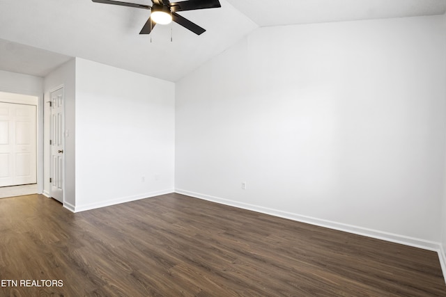 spare room featuring dark wood-type flooring, baseboards, a ceiling fan, and lofted ceiling