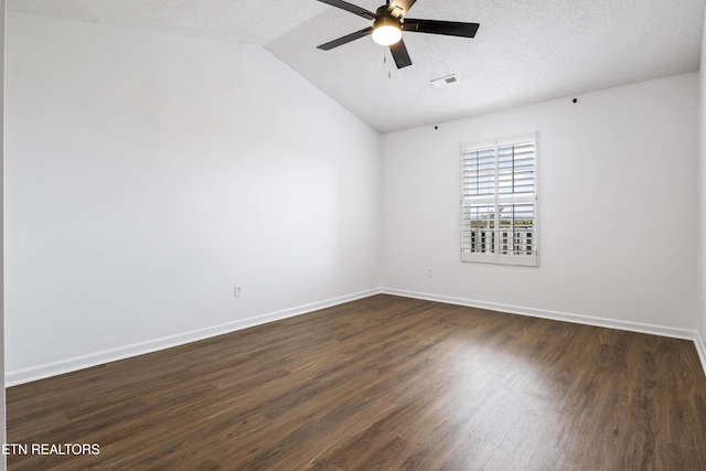 empty room with ceiling fan, vaulted ceiling, visible vents, and dark wood finished floors