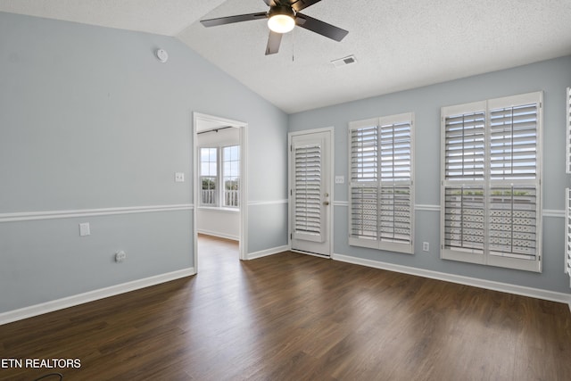 spare room featuring baseboards, vaulted ceiling, a ceiling fan, and wood finished floors