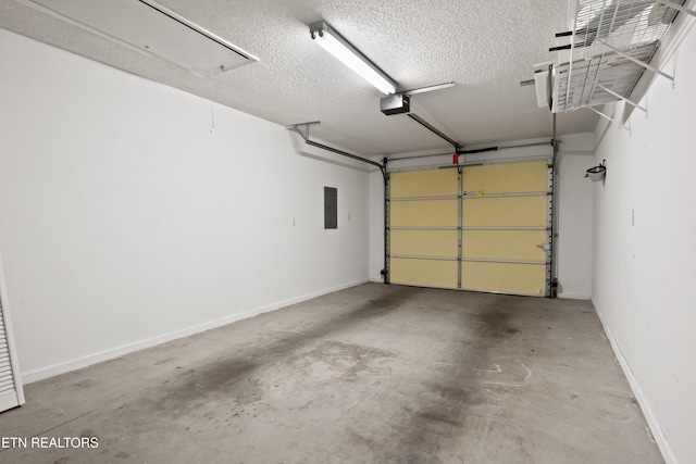 garage with a garage door opener, baseboards, and electric panel