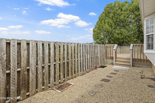 view of yard featuring a fenced backyard and a deck