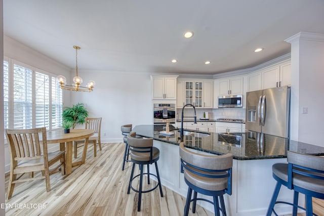 231 Gwinhurst Rd, Knoxville, TN 37934 - kitchen with tasteful backsplash, light wood-type flooring, white cabinetry, appliances with stainless steel finishes, and a sink