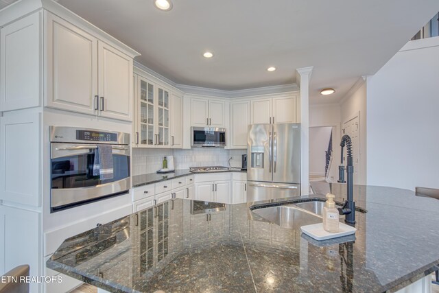 231 Gwinhurst Rd, Knoxville, TN 37934 - kitchen with glass insert cabinets, white cabinets, a sink, appliances with stainless steel finishes, and backsplash