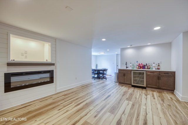 231 Gwinhurst Rd, Knoxville, TN 37934 - bar with a bar, light wood-type flooring, wine cooler, recessed lighting, and a glass covered fireplace