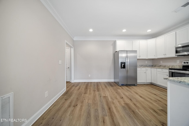 kitchen featuring visible vents, appliances with stainless steel finishes, crown molding, and white cabinetry