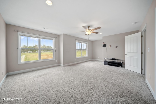 interior space featuring visible vents, baseboards, a ceiling fan, and carpet flooring