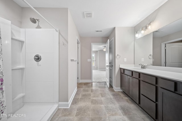 full bath featuring a ceiling fan, vanity, a shower, and visible vents