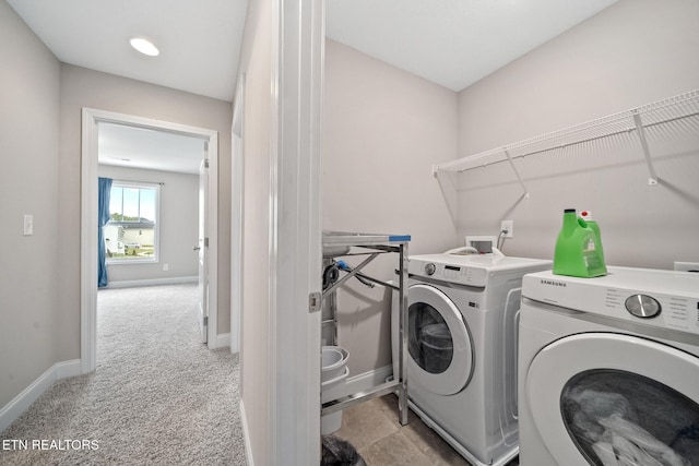 washroom with carpet flooring, baseboards, separate washer and dryer, and laundry area