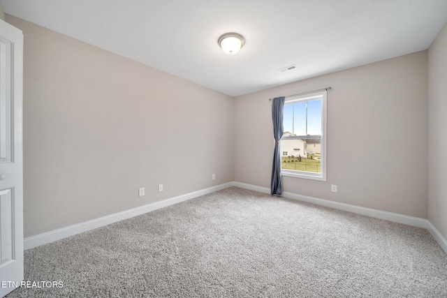 empty room with visible vents, baseboards, and carpet