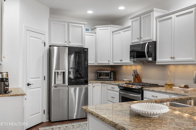 1022 Providence Grove Way, Knoxville, TN 37919 - kitchen featuring light stone countertops, tasteful backsplash, white cabinets, and stainless steel appliances