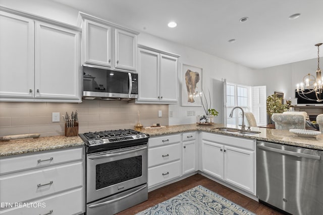 1022 Providence Grove Way, Knoxville, TN 37919 - kitchen featuring stainless steel appliances, an inviting chandelier, white cabinets, and a sink