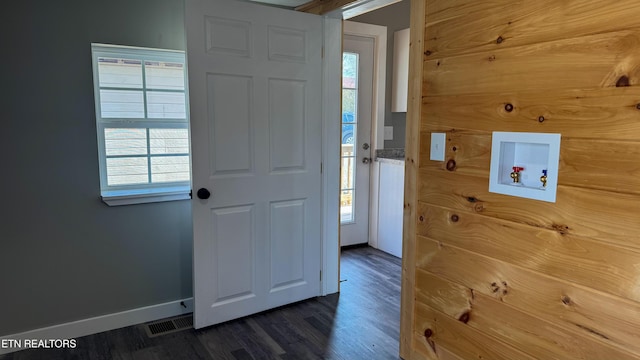 interior space with visible vents, plenty of natural light, baseboards, and dark wood-style flooring
