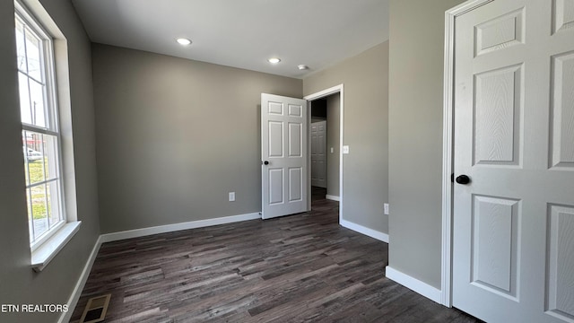 unfurnished bedroom with recessed lighting, visible vents, baseboards, and dark wood-style flooring