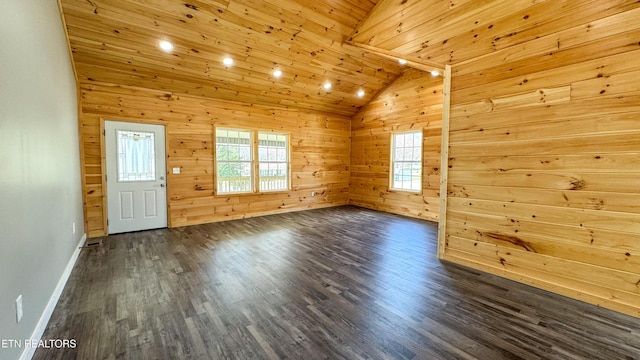 empty room featuring wooden walls, wood ceiling, lofted ceiling, and dark wood-style flooring