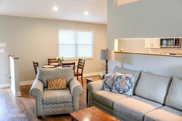 living area featuring recessed lighting, baseboards, and wood finished floors