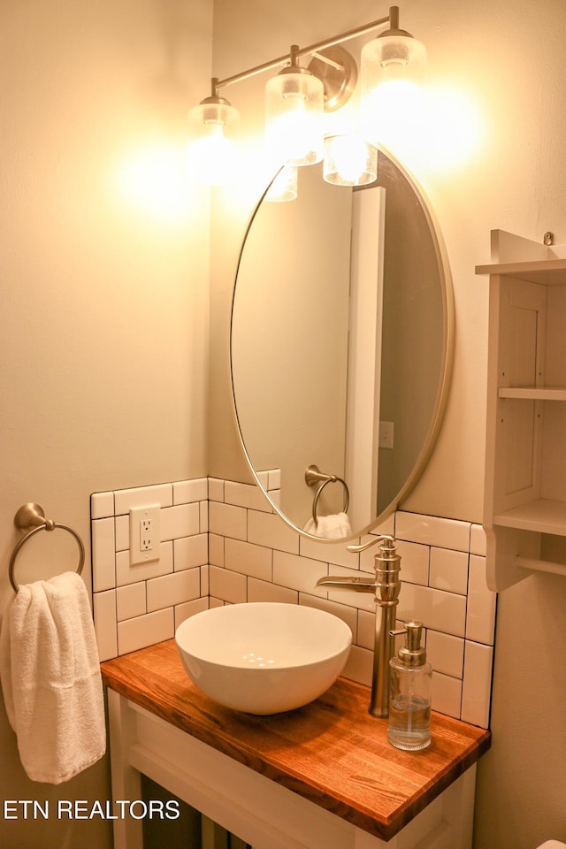 bathroom featuring decorative backsplash and a sink