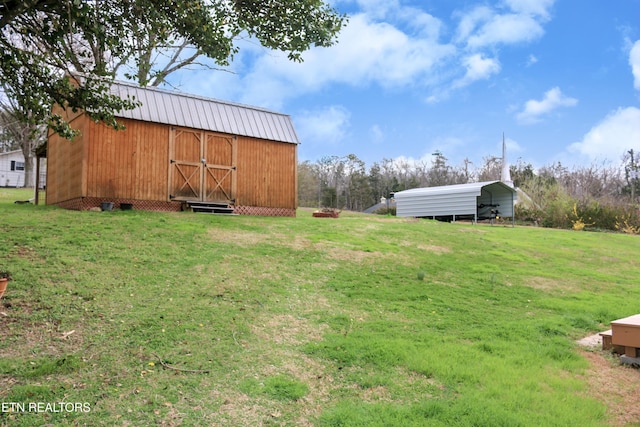 view of yard with a carport and an outdoor structure