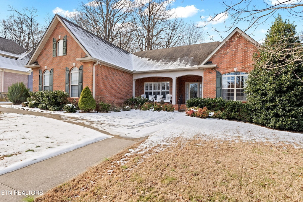 525 Glen Abbey Blvd, Knoxville, TN 37934 - traditional-style house with brick siding, a porch, and roof with shingles