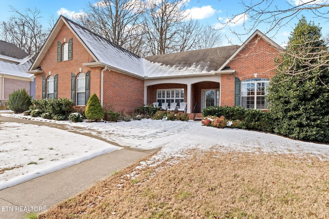 525 Glen Abbey Blvd, Knoxville, TN 37934 - traditional-style house with brick siding, a porch, and roof with shingles