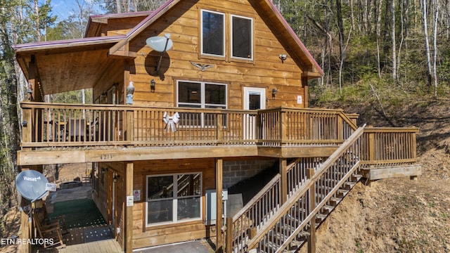 back of property with stairway and a wooden deck