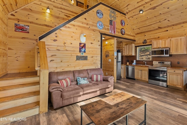 living room with vaulted ceiling, wood ceiling, and wood walls