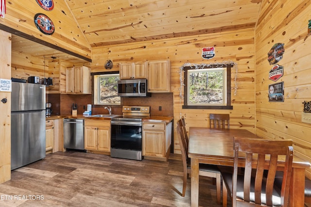kitchen with light brown cabinets, wooden ceiling, a sink, vaulted ceiling, and appliances with stainless steel finishes