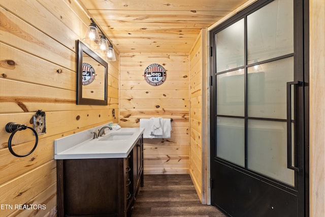 bathroom featuring wooden ceiling, wood walls, wood finished floors, and vanity