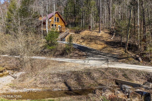 view of street featuring a wooded view