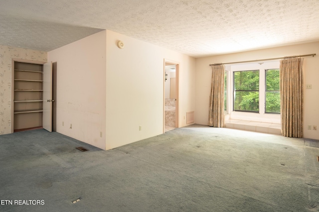 123 Manor Rd, Clinton, TN 37716 - carpeted empty room featuring a textured ceiling