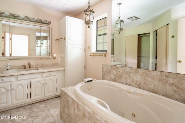 123 Manor Rd, Clinton, TN 37716 - bathroom with a jetted tub, vanity, and tile patterned flooring