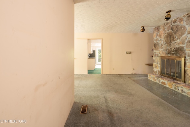 123 Manor Rd, Clinton, TN 37716 - unfurnished living room with a fireplace, a textured ceiling, and carpet floors