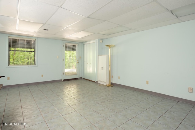 123 Manor Rd, Clinton, TN 37716 - spare room with a drop ceiling, healthy amount of natural light, light tile patterned floors, and baseboards